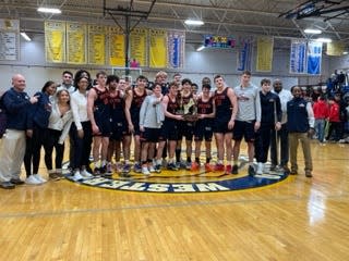 Members of the Milton Academy boys basketball team celebrate after beating St. Sebastian's, 77-76, on Sunday, March 5, 2023 to claim the Class A NEPSAC championship at Western New England University in Springfield.