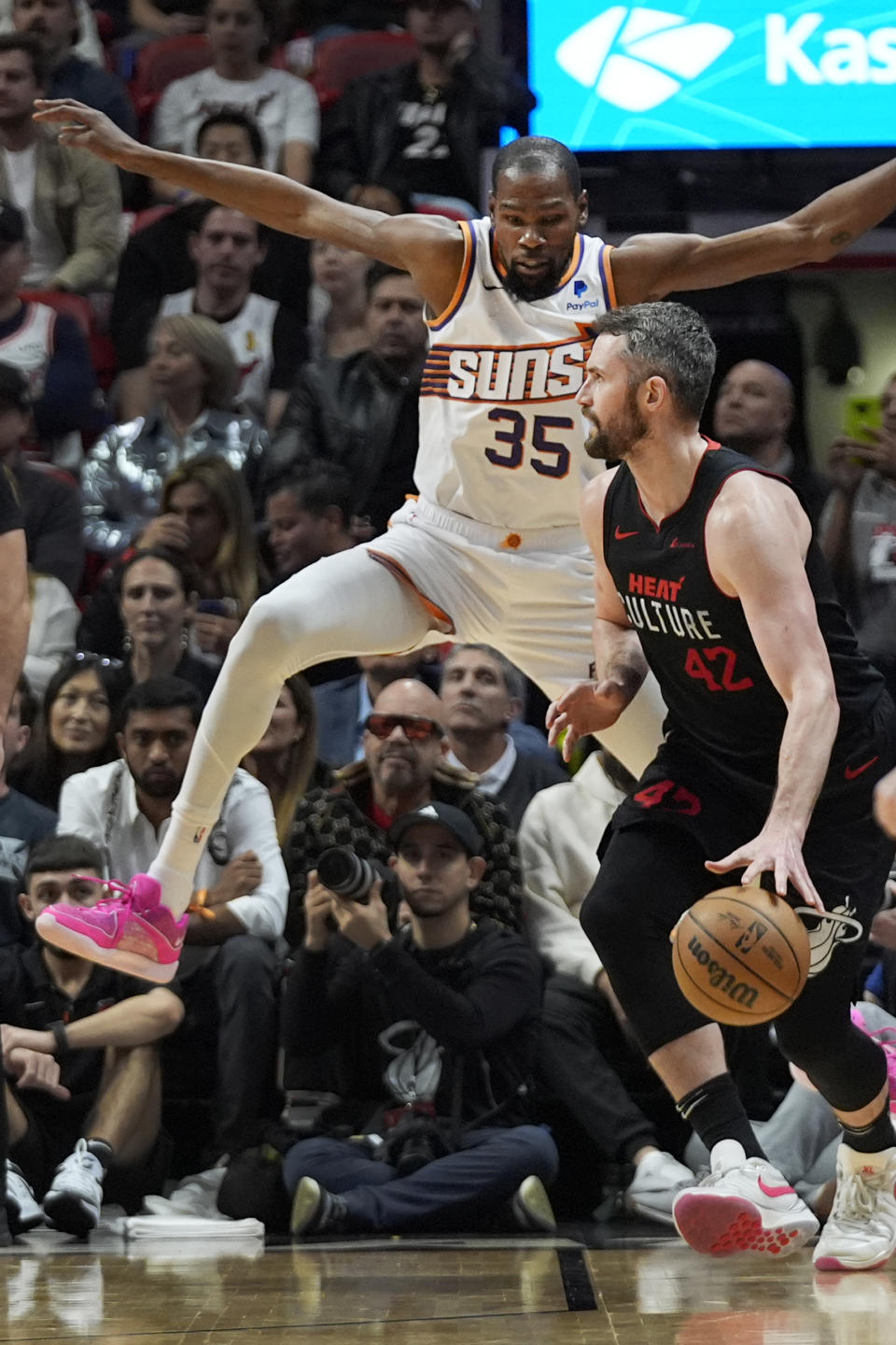 Phoenix Suns forward Kevin Durant (35) attempts to block Miami Heat forward Kevin Love (42) during the first half of an NBA basketball game, Monday, Jan. 29, 2024, in Miami. (AP Photo/Wilfredo Lee)