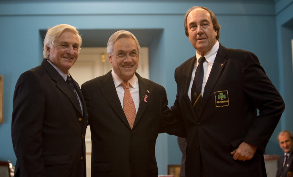 Chilean President Sebastian Pinera (C) poses with  Uruguayans Roberto Canessa (L) and Nando Parrado (R), two of the 16 survivors of an airplane crash in the Chilean Andes in 1972 and who remained lost in the mountains for 72 days, during the commemoration of the 40th anniversary of their tragedy, in Santiago  on October 12 , 2012.    AFP PHOTO/Martin BERNETTI        (Photo credit should read MARTIN BERNETTI/AFP/GettyImages)