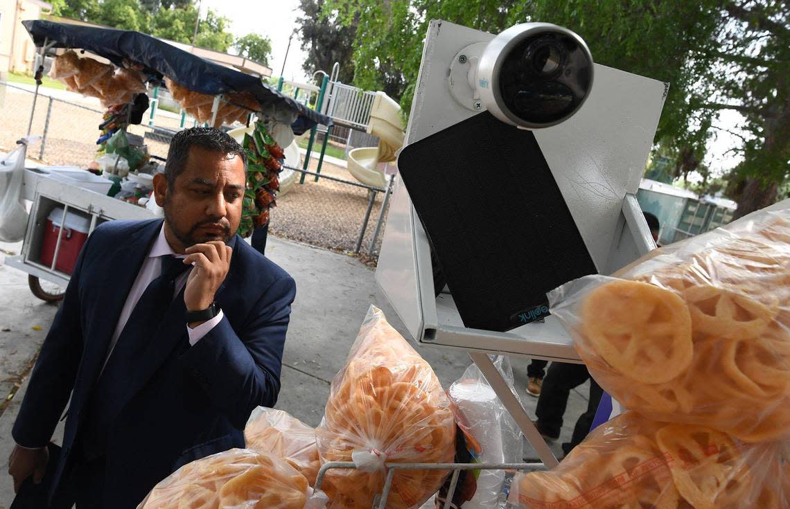 Fresno City Council Member Miguel Arias looks over a mobile food cart equipped with a security camera and solar panel, before a press conference, where the launching of a pilot program was announced for the safety of street food vendors who live and work in Fresno.