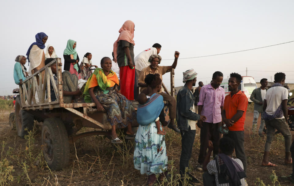 Ethiopian refugees gather n Qadarif region, easter Sudan, Sunday, Nov. 15, 2020. Thousands of Ethiopians fled the war in Tigray region into Sudan. (AP Photo/Marwan Ali)