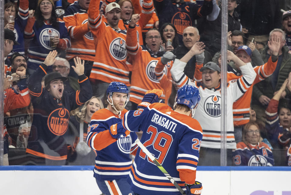 Edmonton Oilers' Connor McDavid (97) and Leon Draisaitl (29) celebrate a goal against the Vegas Golden Knights during the second period of an NHL hockey game in Edmonton, Alberta on Tuesday Nov. 28, 2023. (Jason Franson/The Canadian Press via AP)