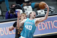 Charlotte Hornets' Cody Zeller (40) grabs a rebound over Chicago Bulls' Lauri Markkanen during the first half of an NBA basketball game Thursday, April 22, 2021, in Chicago. (AP Photo/Charles Rex Arbogast)