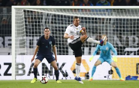 Football Soccer - Germany v England - International Friendly - Signal-Iduna-Park, Dortmund, Germany - 22/3/17 Germany's Lukas Podolski in action with England's Michael Keane Reuters / Wolfgang Rattay Livepic