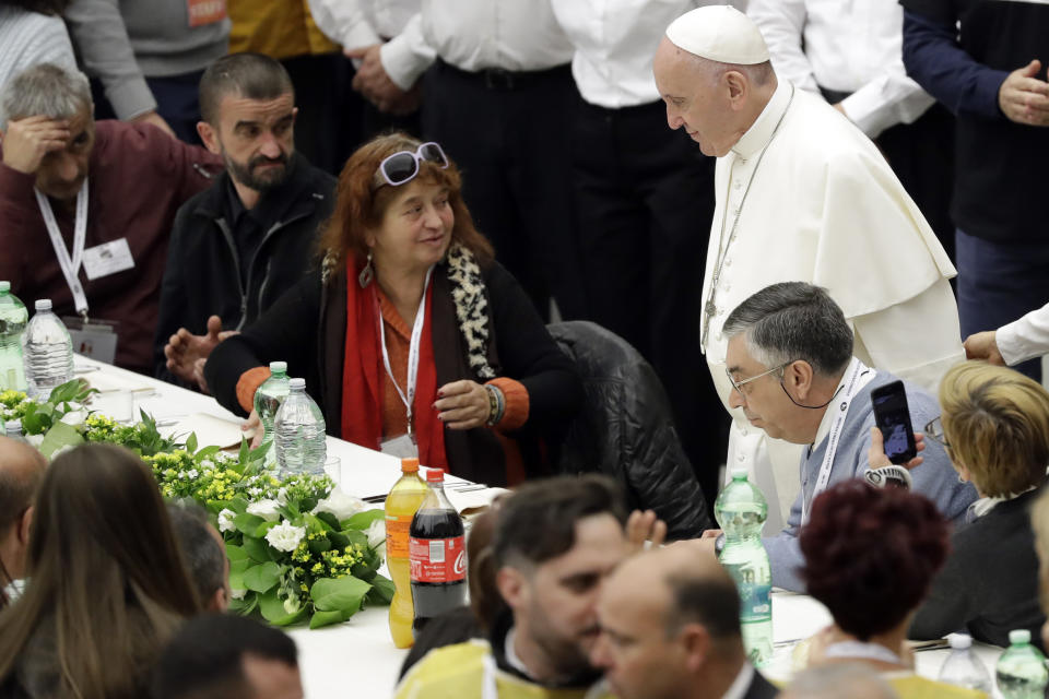 Pope Francis greets people at a lunch, at the Vatican, Sunday, Nov. 18, 2018. Pope Francis is offering several hundred poor people, homeless, migrants, unemployed a lunch on Sunday as he celebrates the World Day of the Poor with a concrete gesture of charity in the spirit of his namesake, St. Francis of Assisi. (AP Photo/Andrew Medichini)