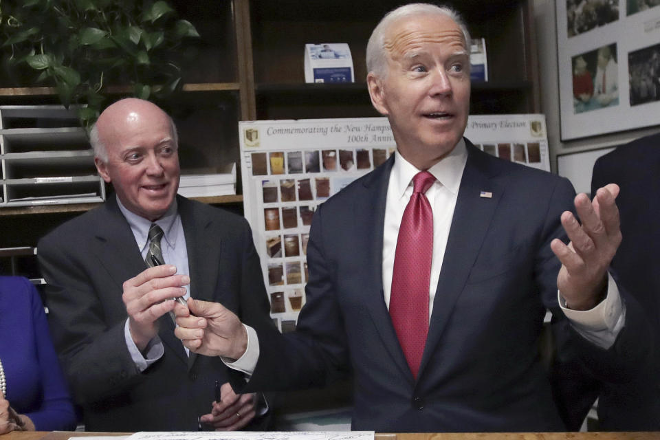 FILE— Then Democratic presidential candidate former Vice President Joe Biden hands the pen to New Hampshire Secretary of State Bill Gardner, left, Nov. 8, 2019, after filing to have his name listed on the New Hampshire primary ballot, in Concord, N.H. Gardner, the nation's longest serving secretary of state, announced Jan. 3, 2022 that he plans on stepping down as Secretary of State and not seek reelection to a 24th term. (AP Photo/Charles Krupa, File)