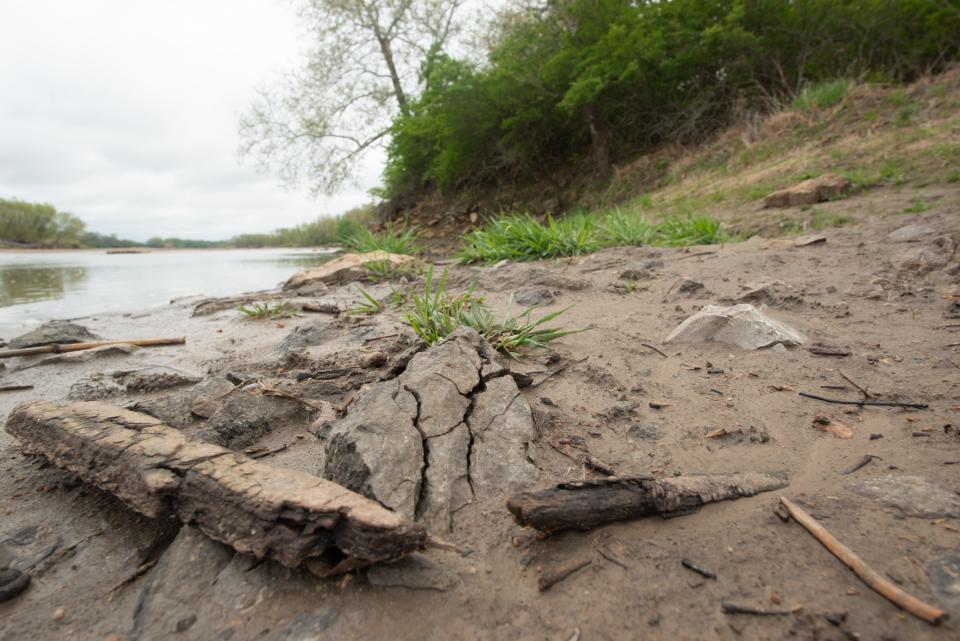 Mud, tree bark, rocks and other debris can be seen Tuesday along the Kansas River in the area of the boat ramp at Kaw River State Park.