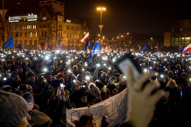 People take part in an anti-government protest in support of free judiciary in Poznan