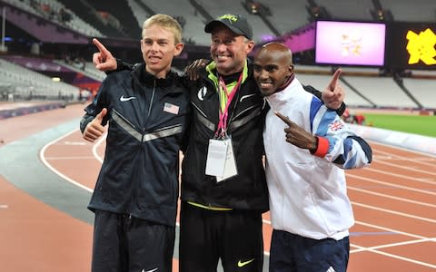 Mo Farah celebrates winning the men's 10,000m final at London 2012 alongside silver medallist Galen Rupp and Alberto Salazar - Credit: PA