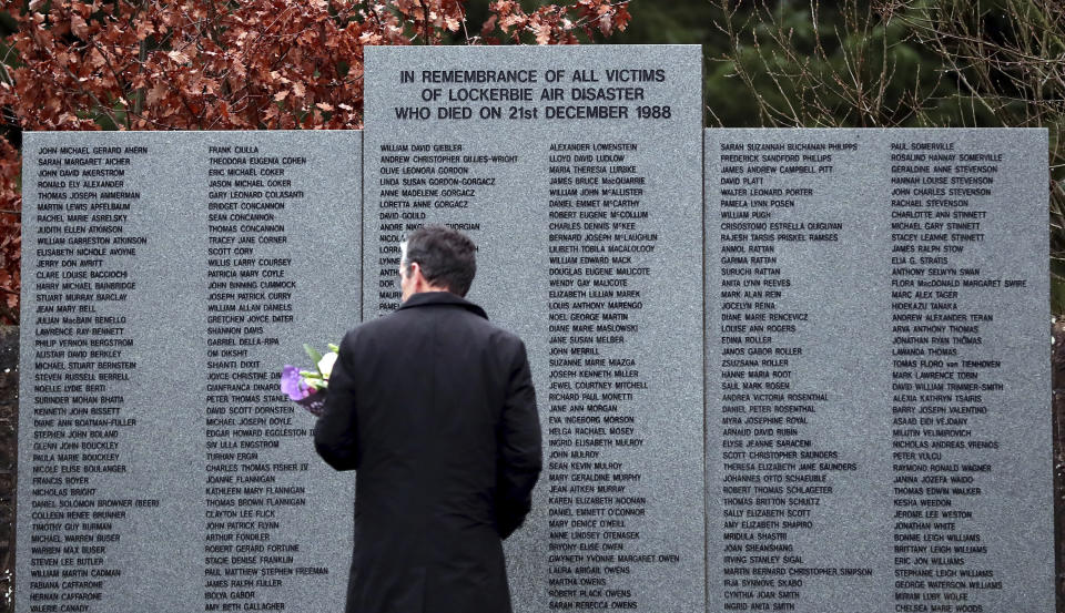 FILE - A man looks at the main memorial stone in memory of the victims of the bombing of Pan Am flight 103, in the garden of remembrance near Lockerbie, Scotland Friday Dec. 21, 2018. U.S. and Scottish authorities said Sunday, Dec. 11, 2022 that the Libyan man suspected of making the bomb that destroyed a passenger plane over Lockerbie, Scotland, in 1988 is in U.S. custody. (AP Photo/Scott Heppell, File)