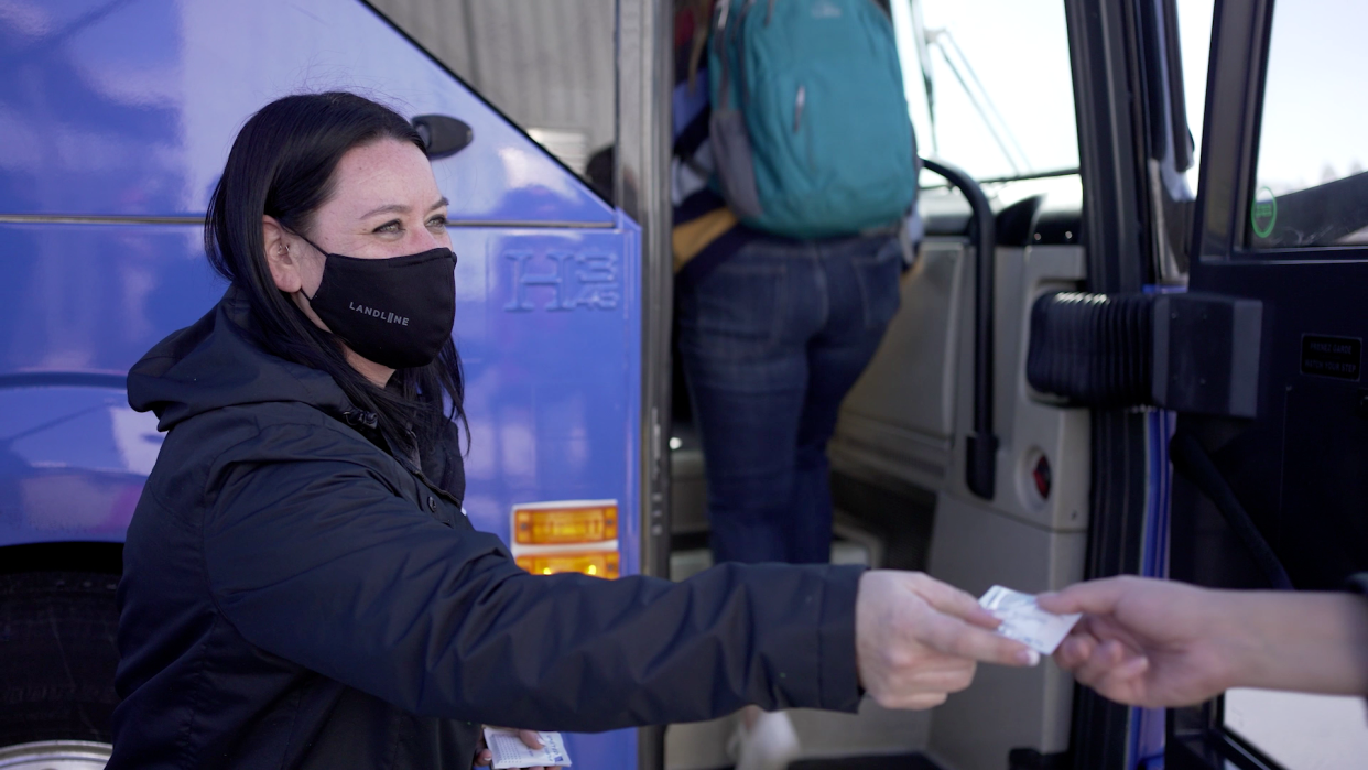 A Landline employee takes a boarding pass from a passenger. Landline and United Airlines are partnering to provide wingless flights from Northern Colorado Municipal Airport in Loveland.