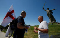 England's fans talk in front of "The Motherland Calls" monument at the Mamayev Kurgan World War Two memorial complex in Volgograd, Russia June 18, 2018. REUTERS/Gleb Garanich