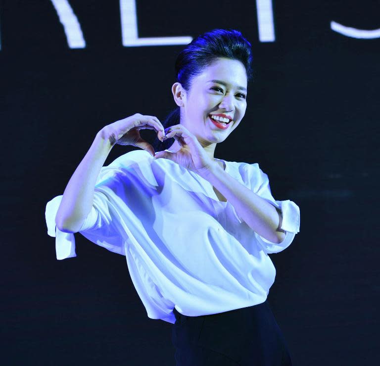 Japanese porn star Sola Aoi poses for photos during a commercial event in Hangzhou, east China's Zhejiang province, in August 2014