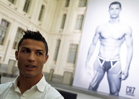 Portugal's soccer star Cristiano Ronaldo speaks with reporters during the launching ceremony of his CR7 by Cristiano Ronaldo underwear line at Madrid's city hall October 31, 2013. REUTERS/Sergio Perez