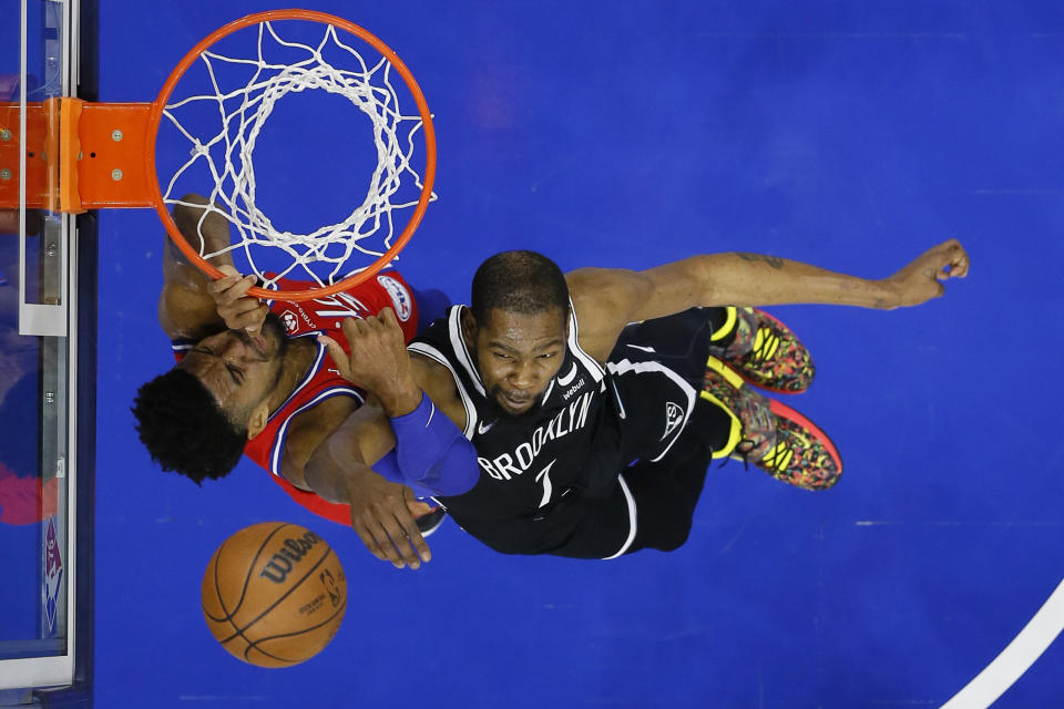 Philadelphia 76ers' Tobias Harris, left, cannot get a shot past Brooklyn Nets' Kevin Durant during the first half of an NBA basketball game, Friday, Oct. 22, 2021, in Philadelphia. (AP Photo/Matt Slocum)