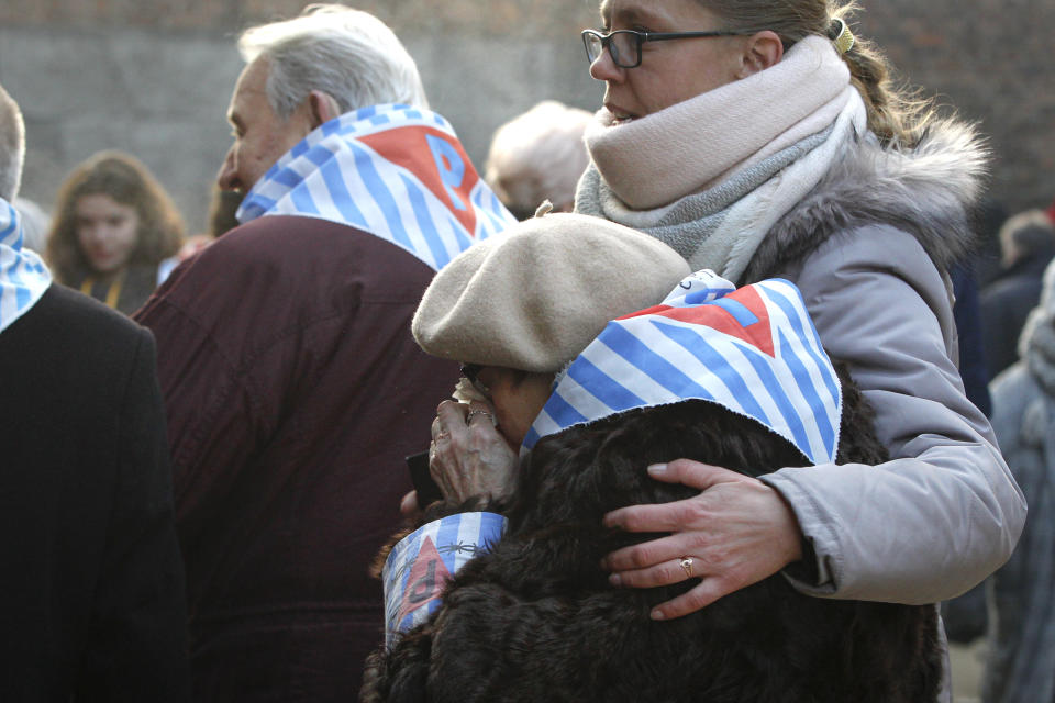 A survivor is comforted during the ceremony.