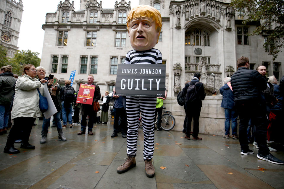 A man wearing a giant Boris Johnson mask, dressed as a prisoner, stands outside the Supreme Court in London, where judges have ruled that Prime Minister Boris Johnson's advice to the Queen to suspend Parliament for five weeks was illegal (Jonathan Brady/PA Wire)