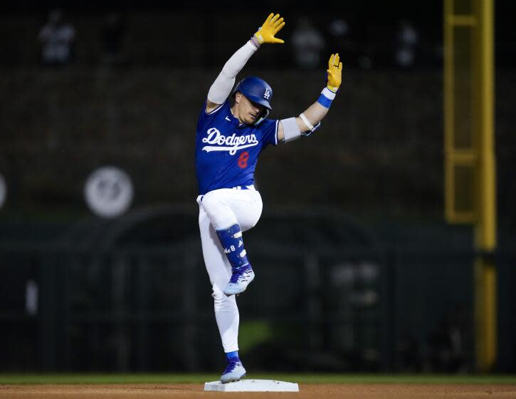 The Dodgers' Kiké Hernández celebrates after doubling during a spring training game against the Cleveland Guardians