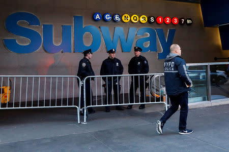 NYPD officers stand outside the New York Port Authority Bus Terminal subway station entrance after reports of an explosion, in New York City, U.S. December 11, 2017. REUTERS/Brendan McDermid