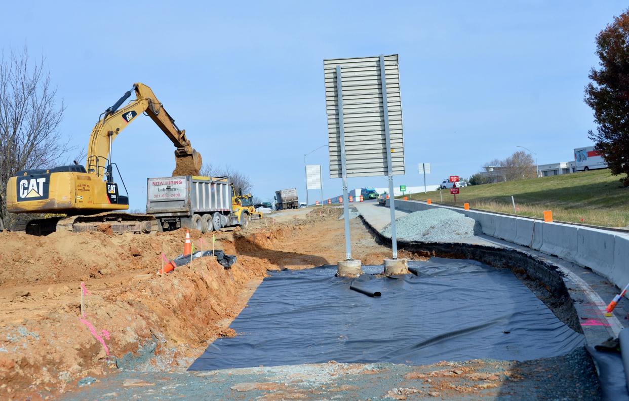 A digger drops dirt in a dump truck on Thursday at one of the construction sites at the Maugans Avenue interchange with Interstate 81. The Maryland State Highway Administration is having an extra lane added to this ramp from southbound I-81 onto Maugans Ave.