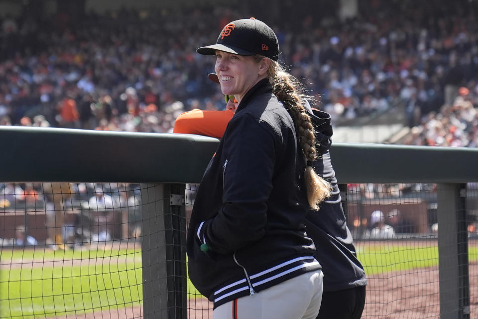 San Francisco Giants major league assistant coach Alyssa Nakken stands in the dugout during the fourth inning of a baseball game against the San Diego Padres in San Francisco, Friday, April 5, 2024. (AP Photo/Jeff Chiu)