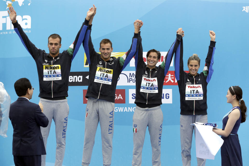 Members of the silver medal-winning team from Italy stand on the podium after the 5km mixed relay open water swim at the World Swimming Championships in Yeosu, South Korea, Thursday, July 18, 2019. (AP Photo/Mark Schiefelbein)