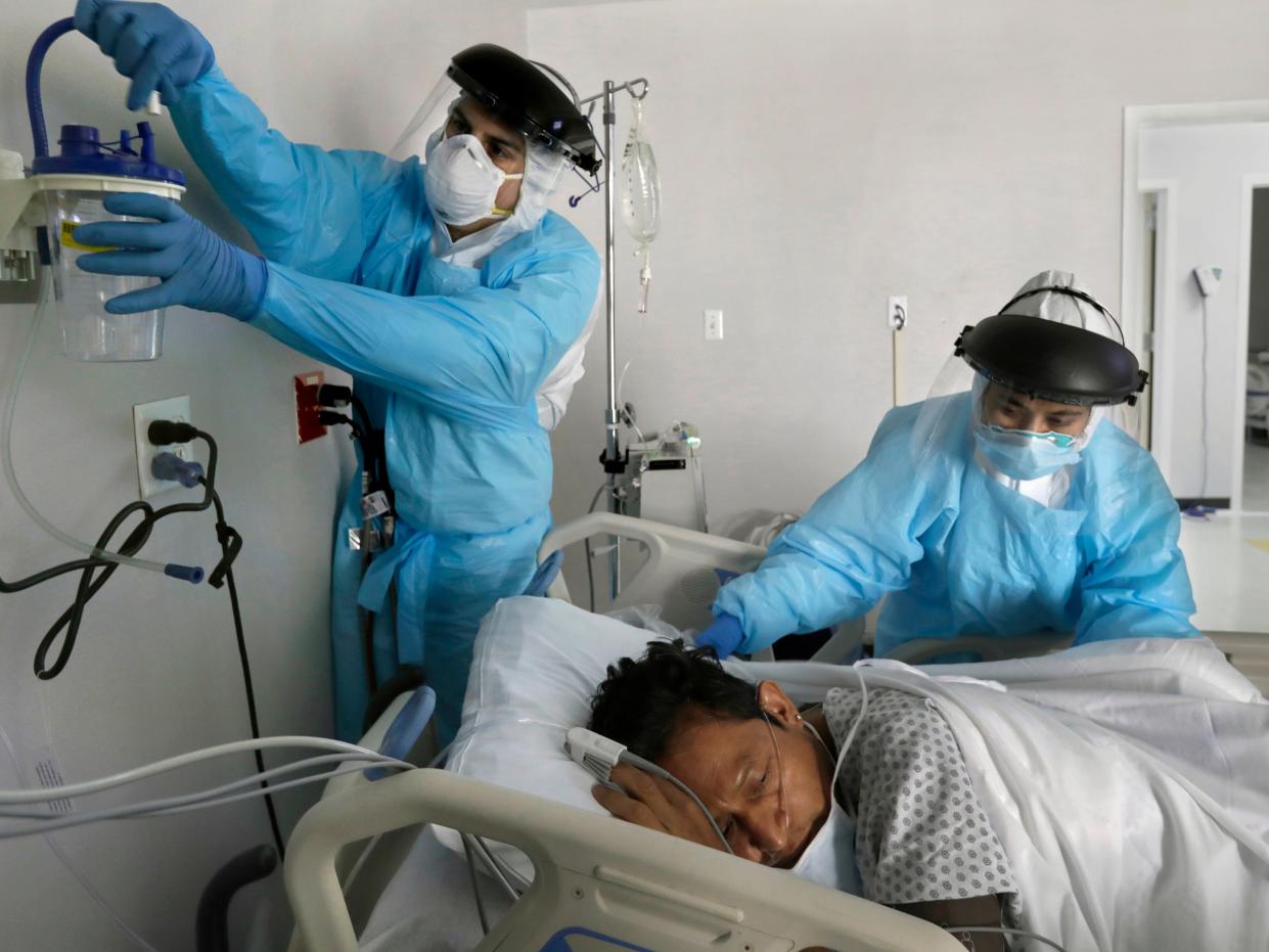 Nurses set up oxygen equipment for a newly arrived COVID-19 patient in the United Memorial Medical Center in Houston, Texas, on May 6, 2020.