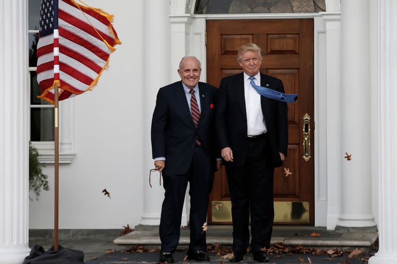 U.S. President-elect Donald Trump stands with former New York City Mayor Rudolph Giuliani before their meeting at Trump National Golf Club in Bedminster