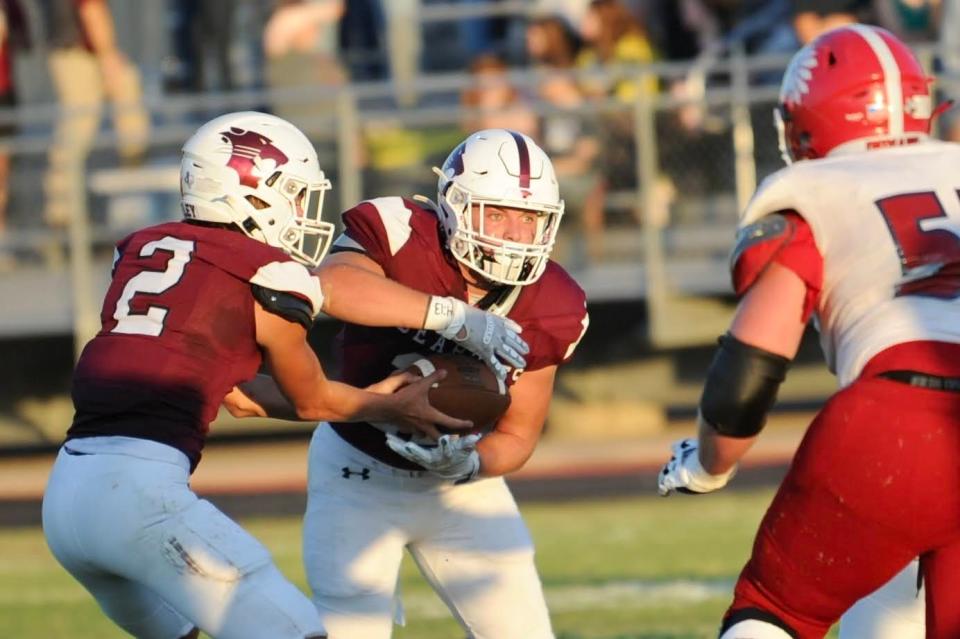 Jim Ned running back Austin Cumpton takes a handoff from quarterback Rodey Hooper against Jim Ned on Aug. 26 in Hawley.