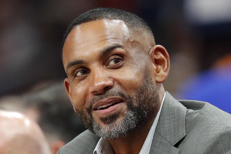 FILE - Atlanta Hawks vice chairman Grant Hill sits court side during the first half of an NBA basketball game against the Dallas Mavericks on Wednesday, Oct. 24, 2018, in Atlanta. Let the recruiting begin. The braintrust for the U.S. — managing director Grant Hill, national team director Sean Ford and coach Steve Kerr — is already well into the process of trying to get players thinking about wearing the red, white and blue at the World Cup in 2023 as well as the Paris Olympics in 2024. (AP Photo/John Bazemore, File)