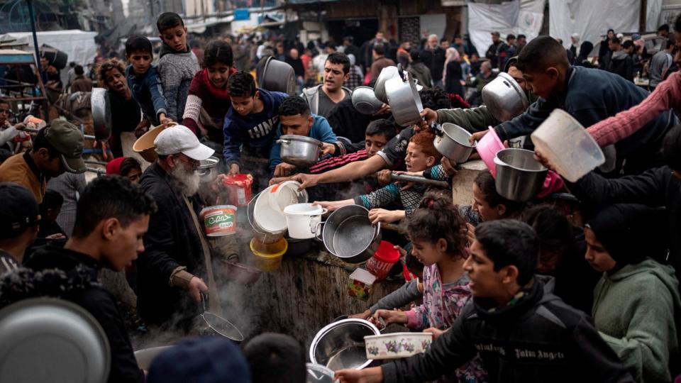 PHOTO: Palestinians line up for a meal in Rafah, Gaza Strip, Dec. 21, 2023.  (Fatima Shbair/AP)