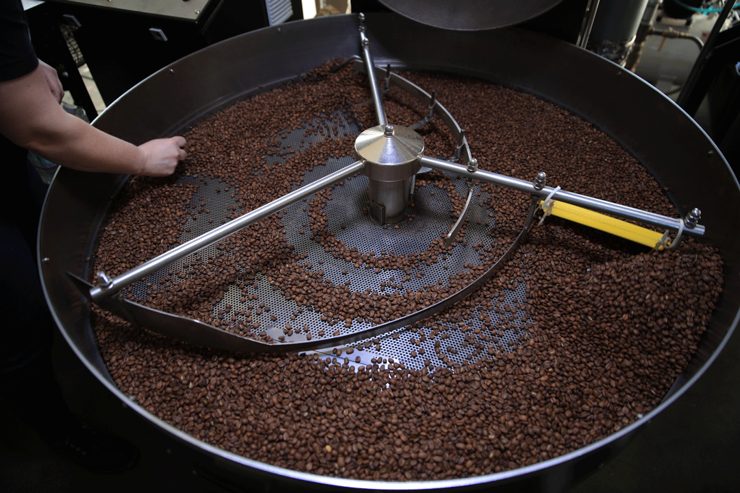 For starters, ask your local barista what beans they are using for drip coffee, or which are in the hopper for espresso. Above, roaster Amy Krauser inspects beans in a vintage Probat UG15 at Cognoscenti Coffee downtown. <span class="copyright">(Allen J. Schaben / Los Angeles Times)</span>