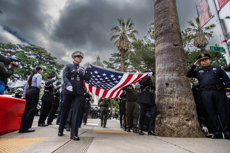 Officers carry the American flag Monday during the California Peace Officers’ Memorial Ceremony at the state Capitol.