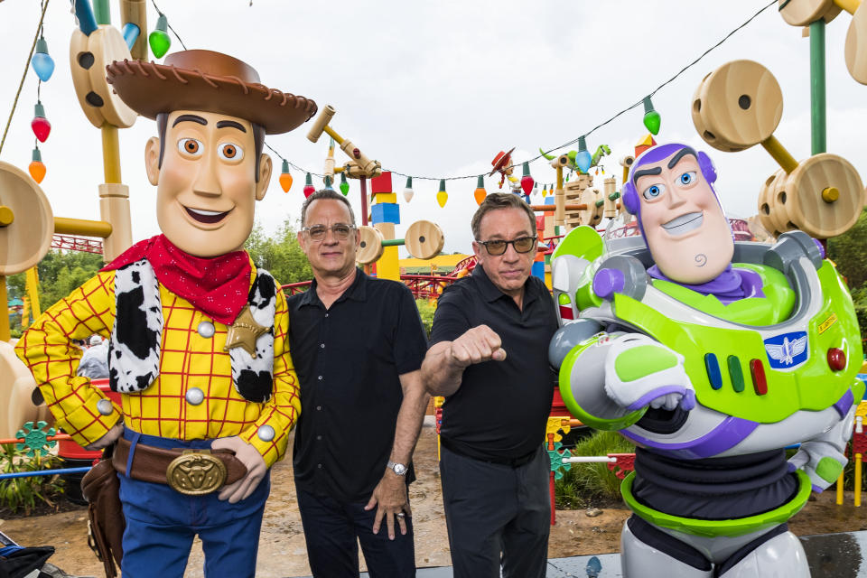 LAKE BUENA VISTA, FLORIDA - JUNE 08: In this Handout provided by Disney Resorts, Stars from DisneyPixars Toy Story 4 Woody (in costume), Tom Hanks (2nd-L), Tim Allen (2nd-R) and Buzz Lightyear (in costume) appear with characters from the film inside Toy Story Land at Disneys Hollywood Studios at Walt Disney World Resort on June 8, 2019 in Lake Buena Vista, Florida. (Photo by Matt Stroshane/Disney Resorts via Getty Images)