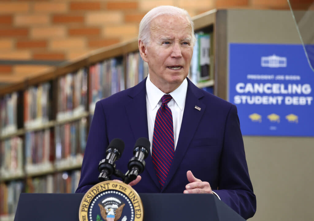 President Joe Biden at a lectern in a library