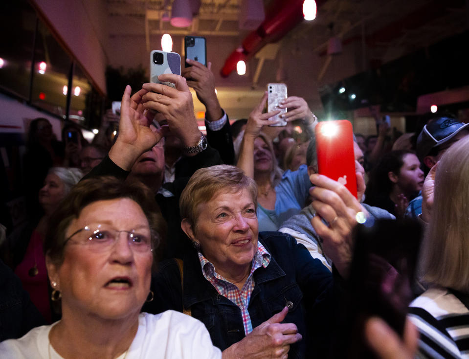 People record videos and take photos on their phones as Gov. Glenn Youngkin supports Yesli Vega during a rally at Gourmeltz in Spotsylvania County, Va., Monday, Oct. 17, 2022. (Tristan Lorei/The Free Lance-Star via AP)