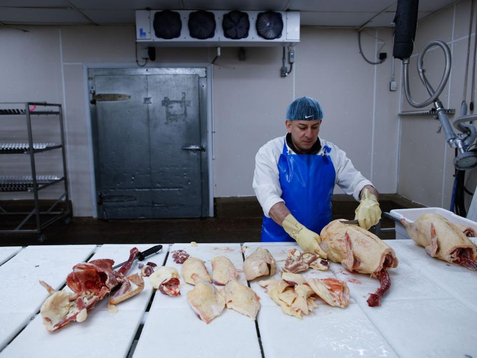 An employee processes duck at Hudson Valley Foie Gras, in Ferndale, New York, on March 3, 2023.