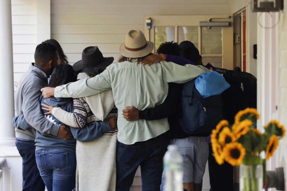 Martha's Vineyard, MA - September 16: Volunteers gather in a circle before helping Venezuelan migrants board busses outside of St. Andrew's Parish House. Two planes of migrants from Venezuela arrived suddenly two days prior causing the local community to mobilize and create a makeshift shelter at the church. (Photo by Carlin Stiehl for The Boston Globe via Getty Images)