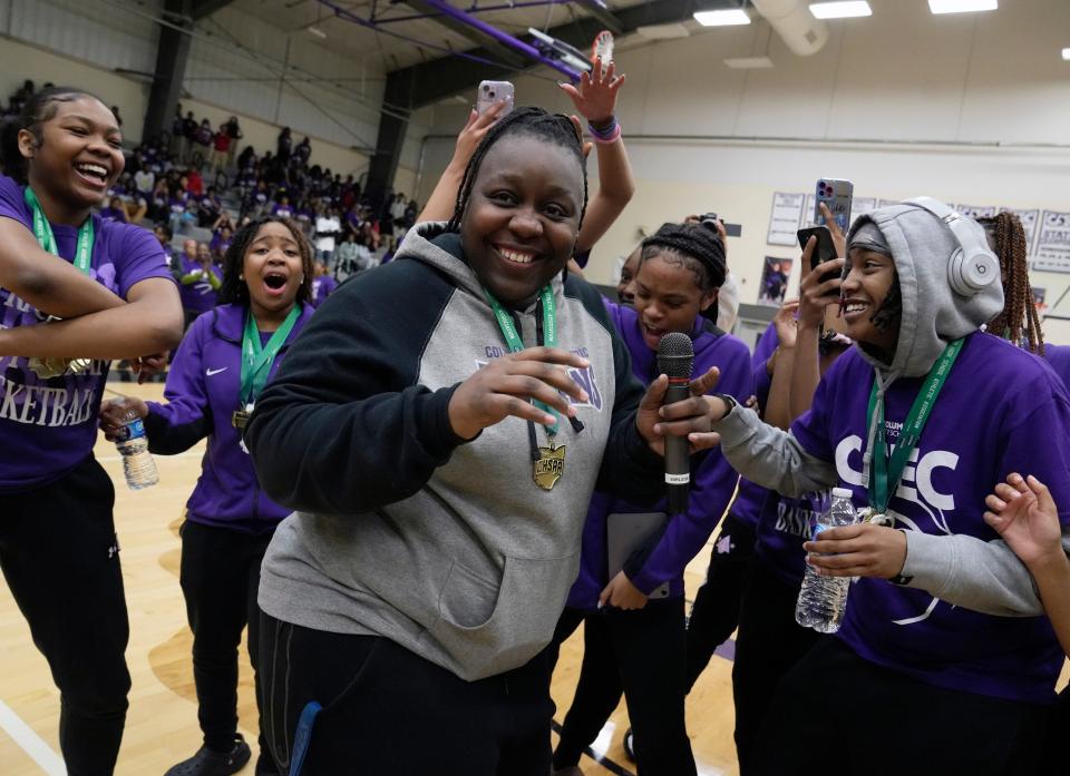 Africentric coach Janicia Anderson and her players celebrate last year's state title during a rally at the school. The Nubians are seeking their 17th district title in 20 seasons.