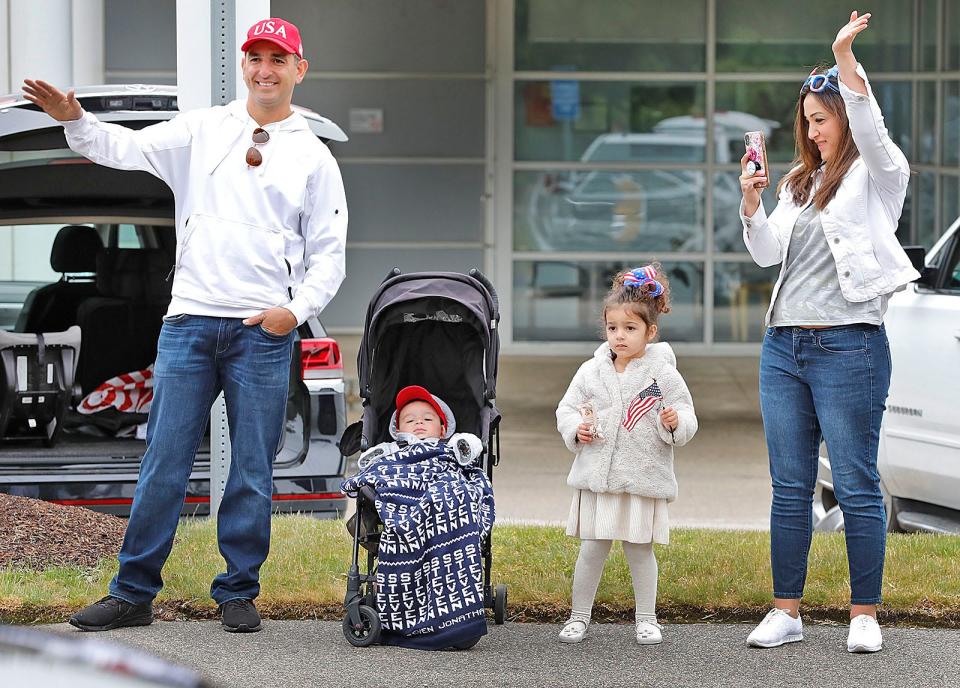 From left, Michael Hajjar, 4-month-old Steven, 3-year-old Juliana and Christina Hajjar, of Abington, watch Weymouth's Memorial Day parade on Pleasant Street on Monday, May 31, 2021.