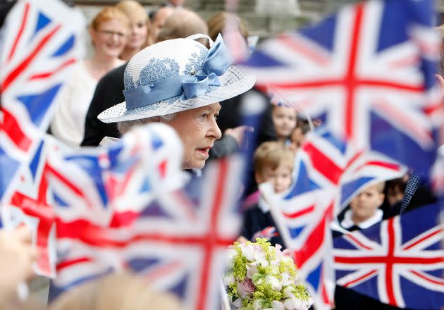 Schoolchildren wave Union flags as Queen Elizabeth II leaves St Paul's Cathedral in London on June 21, 2011. (Photo: Akira Suemori/Pool via AP)
