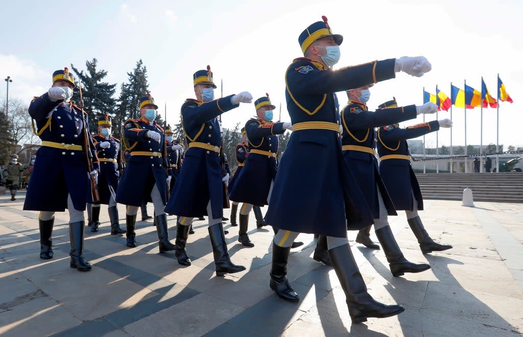 Romanian presidential honour guard soldiers march during a military ceremony held to mark Romania’s Little Union Day at the Tomb of the Unknown Soldier Memorial in Bucharest (EPA)