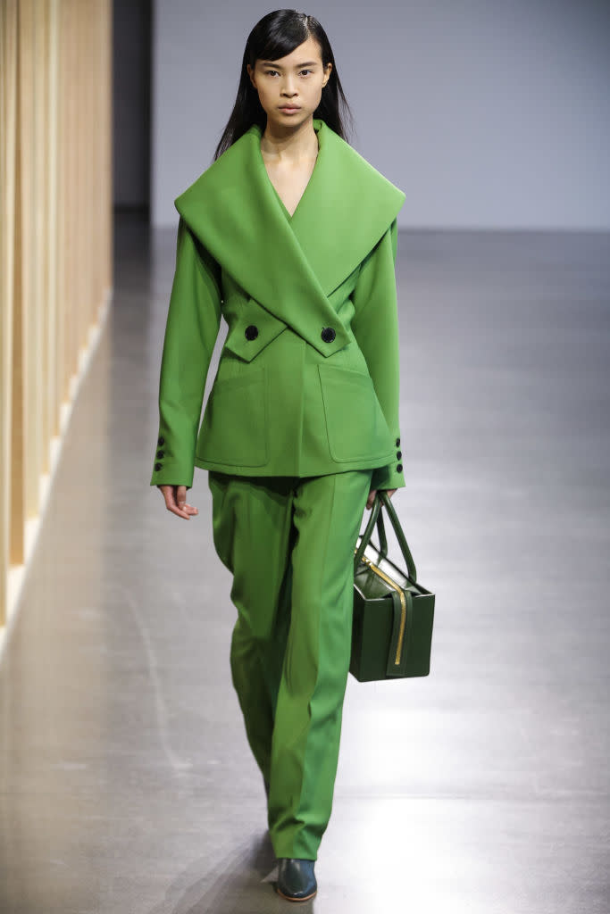 <p>Model wears a green pantsuit at the fall 2018 Claudia Li show. (Photo: Getty Images) </p>