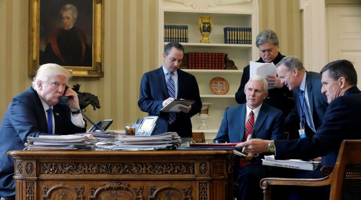 El presidente Donald Trump en la Oficina Oval de la Casa Blanca con su jefe de gabinete Reince Priebus, el vicepresidente Mike Pence, su asesor principal Steve Bannon, su vocero Sean Spicer y su entonces asesor de seguridad nacional Michael Flynn. (Reuters)