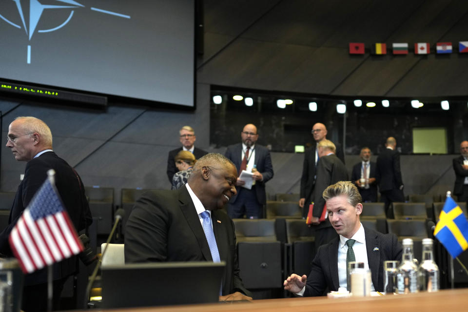 United States Secretary of Defense Lloyd Austin, left, speaks with Sweden's Defense Minister Pal Jonson during a meeting of the North Atlantic Council in defense ministers format at NATO headquarters in Brussels, Thursday, Oct. 12, 2023. (AP Photo/Virginia Mayo)