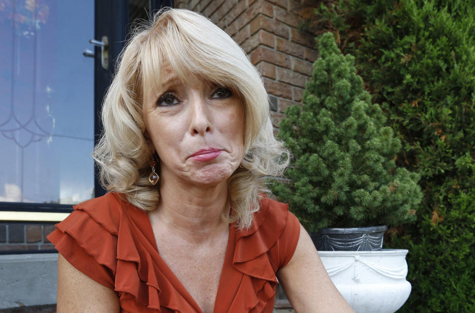 FILE - In this file photo from Aug. 19, 2013, Eileen Battisti sits on the stairs in front of her home in Aliquippa, Pa. Beaver County Common Pleas Judge Gus Kwidis ruled April 22, 2014, to turn down Battisti's request to reverse the sale of her $280,000 house at a tax auction three years ago over $6.30 in unpaid interest. (AP Photo/Keith Srakocic, File)