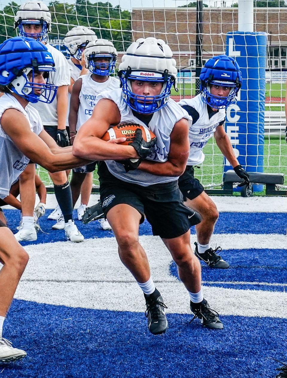 Brookfield Central running back Nick Foster takes a handoff from quarterback Mason Medved during the first day of high school football practice on Tuesday, August 1, 2023.
