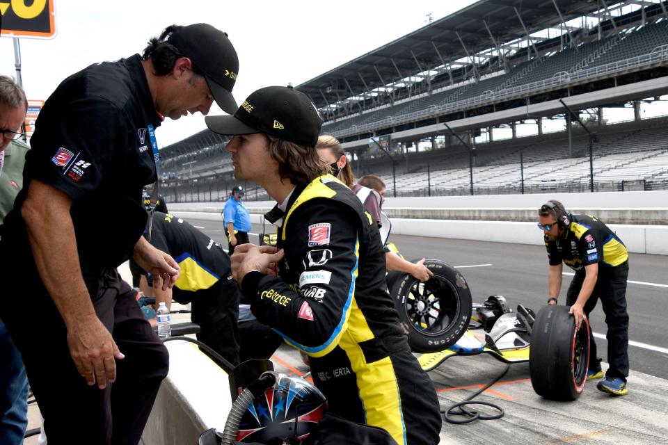 Andretti Autosport with Curb-Agajanian driver Colton Herta (26) talks with his father, Bryan, after stalling on the track during practice and qualifications day Friday, Aug. 13, 2021, ahead of Saturday's NASCAR Xfinity Series Pennzoil 150 and IndyCar Grand Prix doubleheader. 