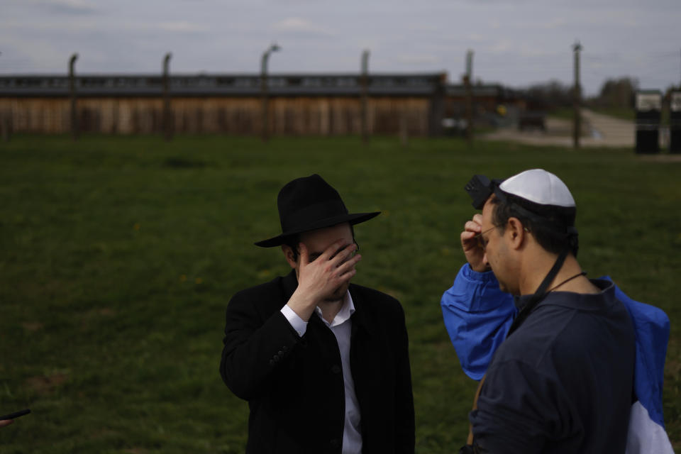 Orthodox Jews pray during in the annual 'March of the Living', a trek between two former Nazi-run death camps, in Oswiecim, Poland, Tuesday, April 18, 2023 to mourn victims of the Holocaust and celebrate the existence of the Jewish state. (AP Photo/Michal Dyjuk)