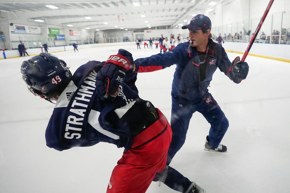 Jul 2, 2023; Columbus, Ohio, USA;  Assistant coach Jared Boll works with defenseman Andrew Strathmann (49) during the Columbus Blue Jackets development camp at the OhioHealth Chiller North in Lewis Center. 